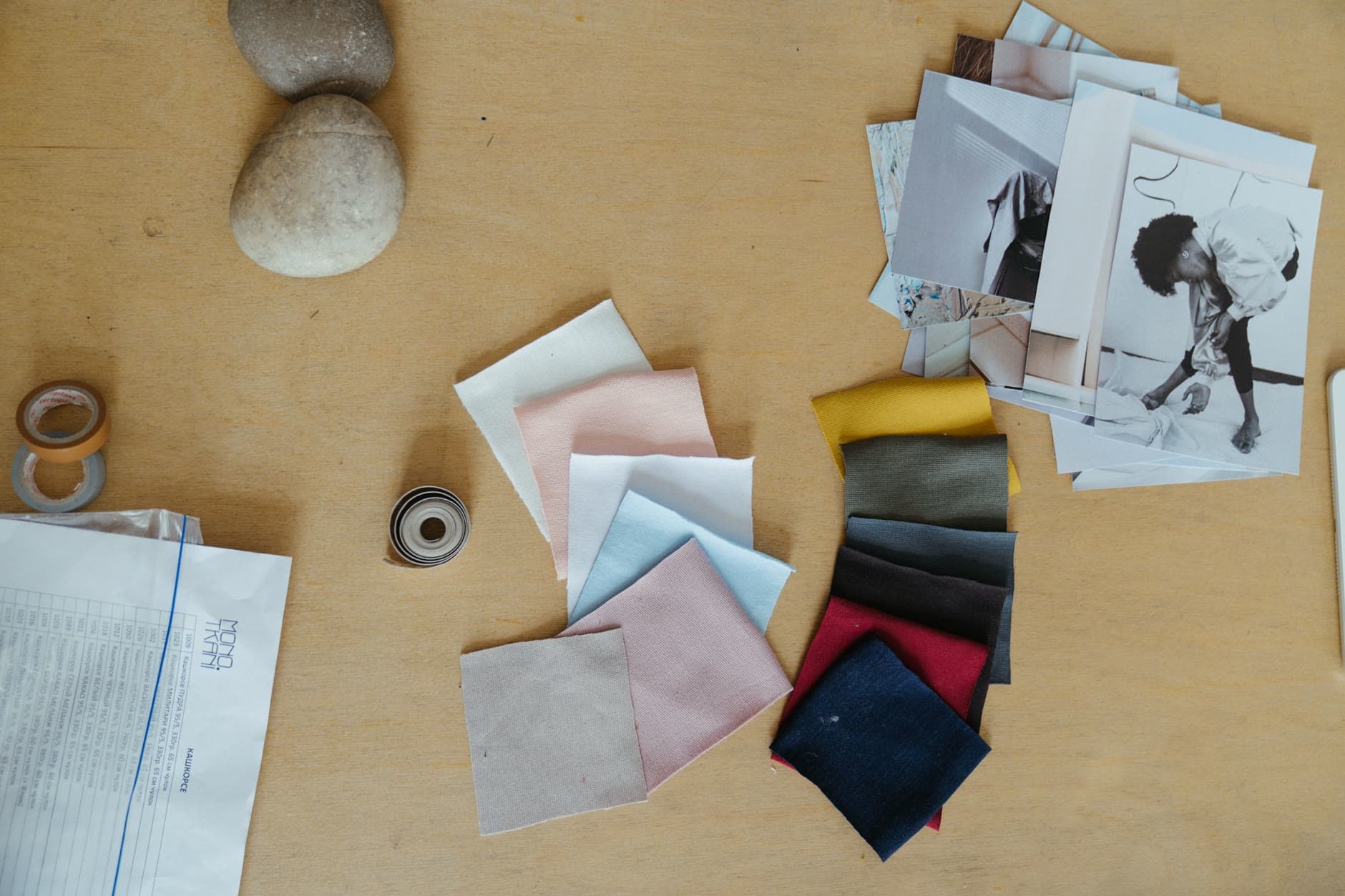 Fabric swatches in two color families laid out on a work table, the kind of samples a client signs on a selection sheet