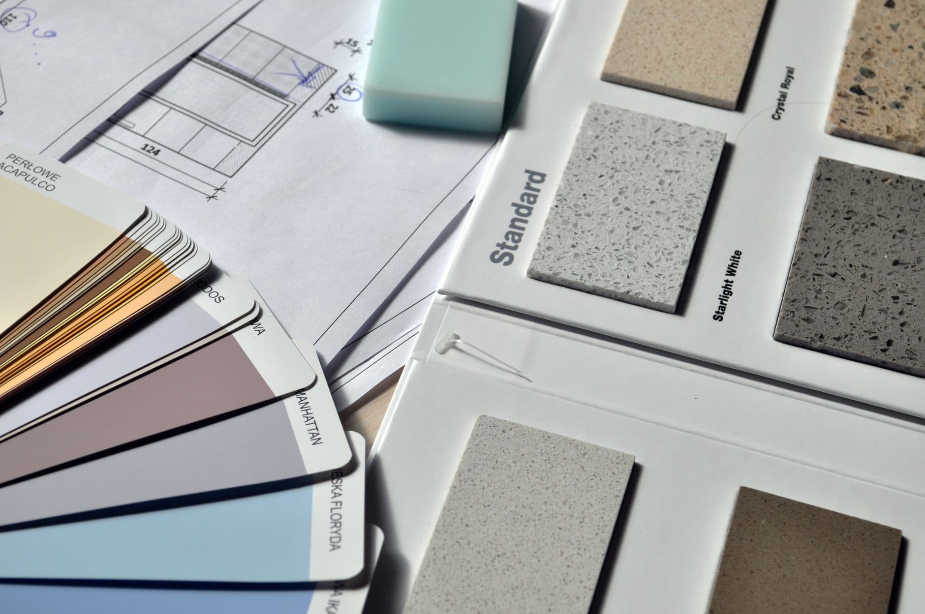 Tile samples and paint swatches laid out on a table, the kind of finish picks that each get their own row on a selection sheet.