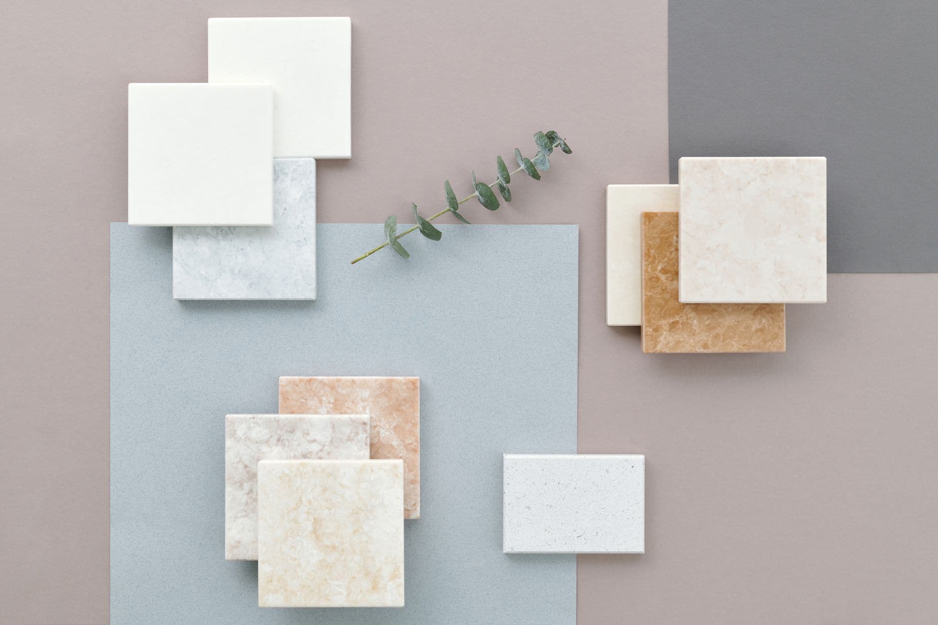 Tile, paint, and material samples spread on a table, the same mix of picks a selection sheet and a finish schedule both track.